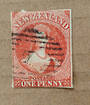 NEW ZEALAND 1855 1d Carmine. Quite a nice copy but light postmark across face. Cut square touching dowb left and cut into frame