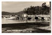 Real Photograph by T G Palmer & Son of Mansion House Bay Kawau Island. Wharf and Launches up close. - 44794 - Postcard