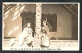 Real Photograph by N S Seaward of Maoris pose before a model hut Rotorua. - 49666 - Postcard